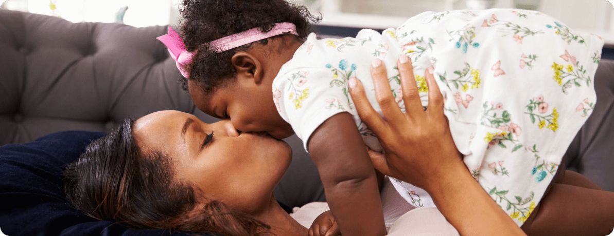 Mother kissing her baby