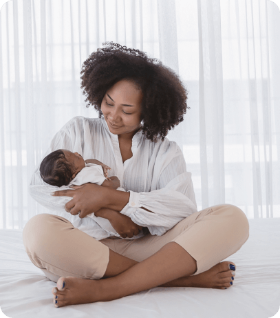 Mother smiling at baby in her arms