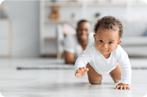 Father encouraging child to crawl