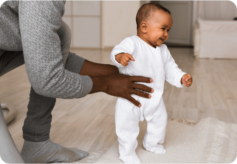 Father helping child to stand