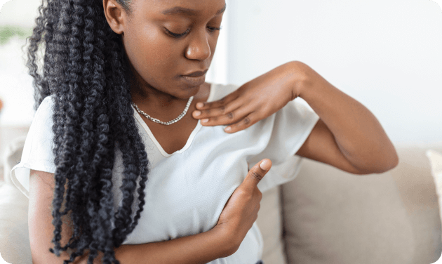 Woman examining her breast