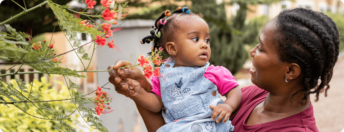 mother and daughter playing with flowers