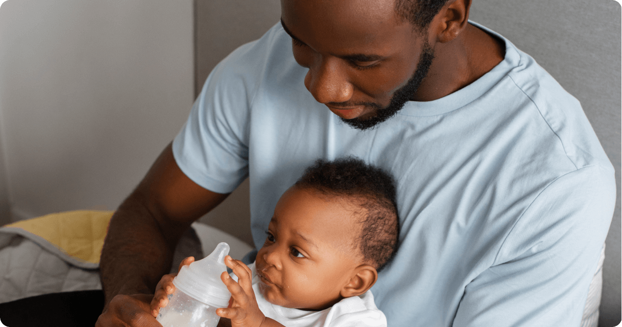 Father feeding a baby